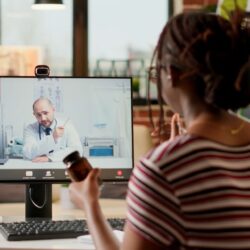 Black female patient engages with doctor on computer screen | Telehealth services boom | Vanguard Communications | Denver