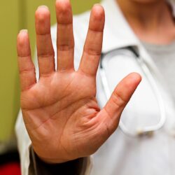 Doctor in white holding up a high five symbolizing the 5 Ps of marketing | Vanguard Communications