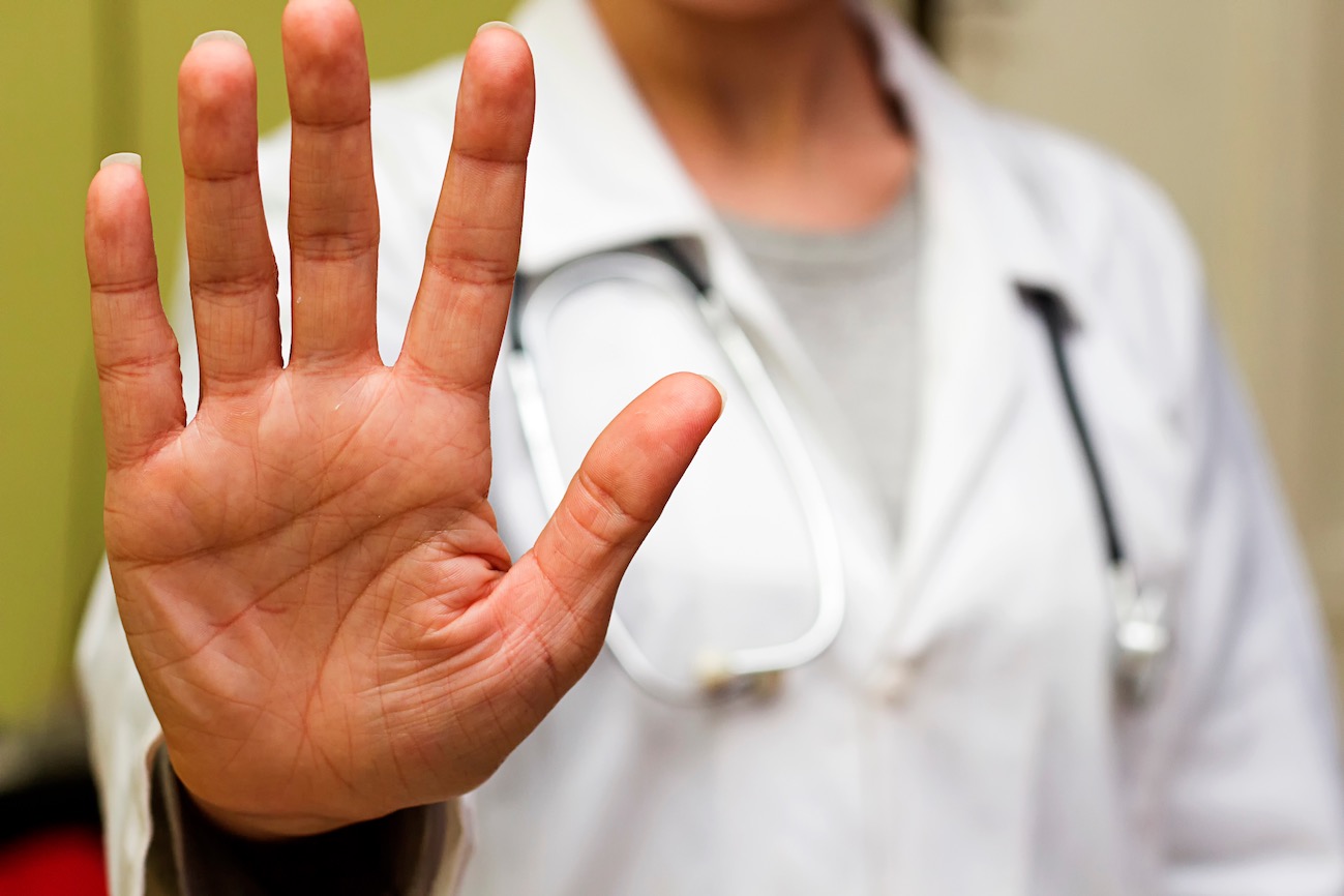 Doctor in white holding up a high five symbolizing the 5 ps of marketing | Vanguard Communications