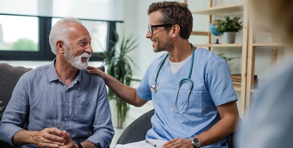 Doctor using active listening with older male patient | Vanguard Communications | Denver, CO & Jacksonville, FL