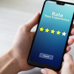 Hands holding cellphone and selecting 5 star rating | Vanguard Communications | Denver, CO