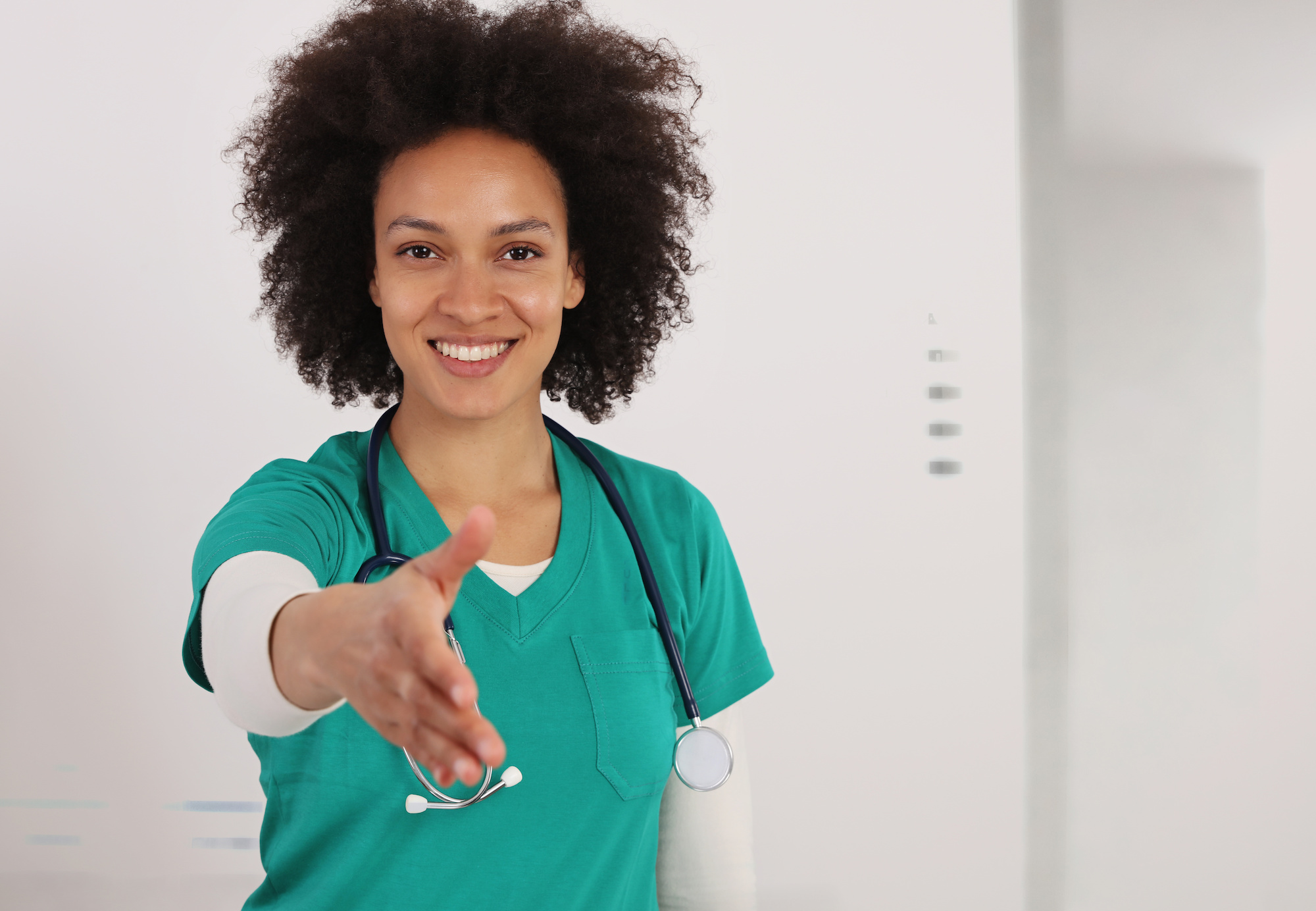 Nurse extending hand to greet patients is part of medical branding | Vanguard Communications | Denver, CO | San Jose, CA | Jacksonville, FL