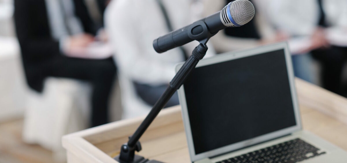 Blogging for patient trust | Vanguard Communications | Microphone on podium