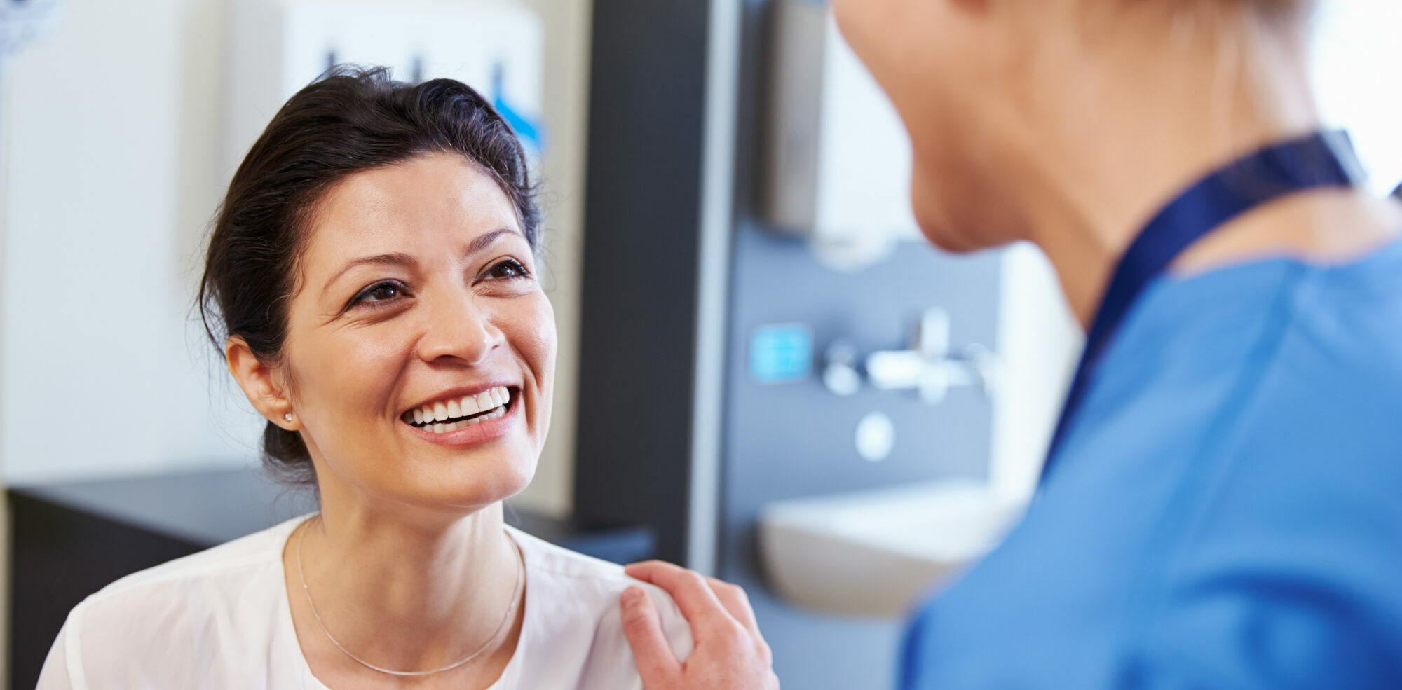 female patient smiling at her doctor after a good patient experience | Vanguard Communications | Denver