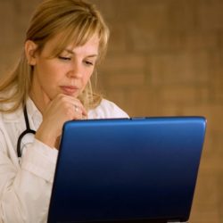 Doctor blogging | Vanguard Communications | Female doctor at laptop