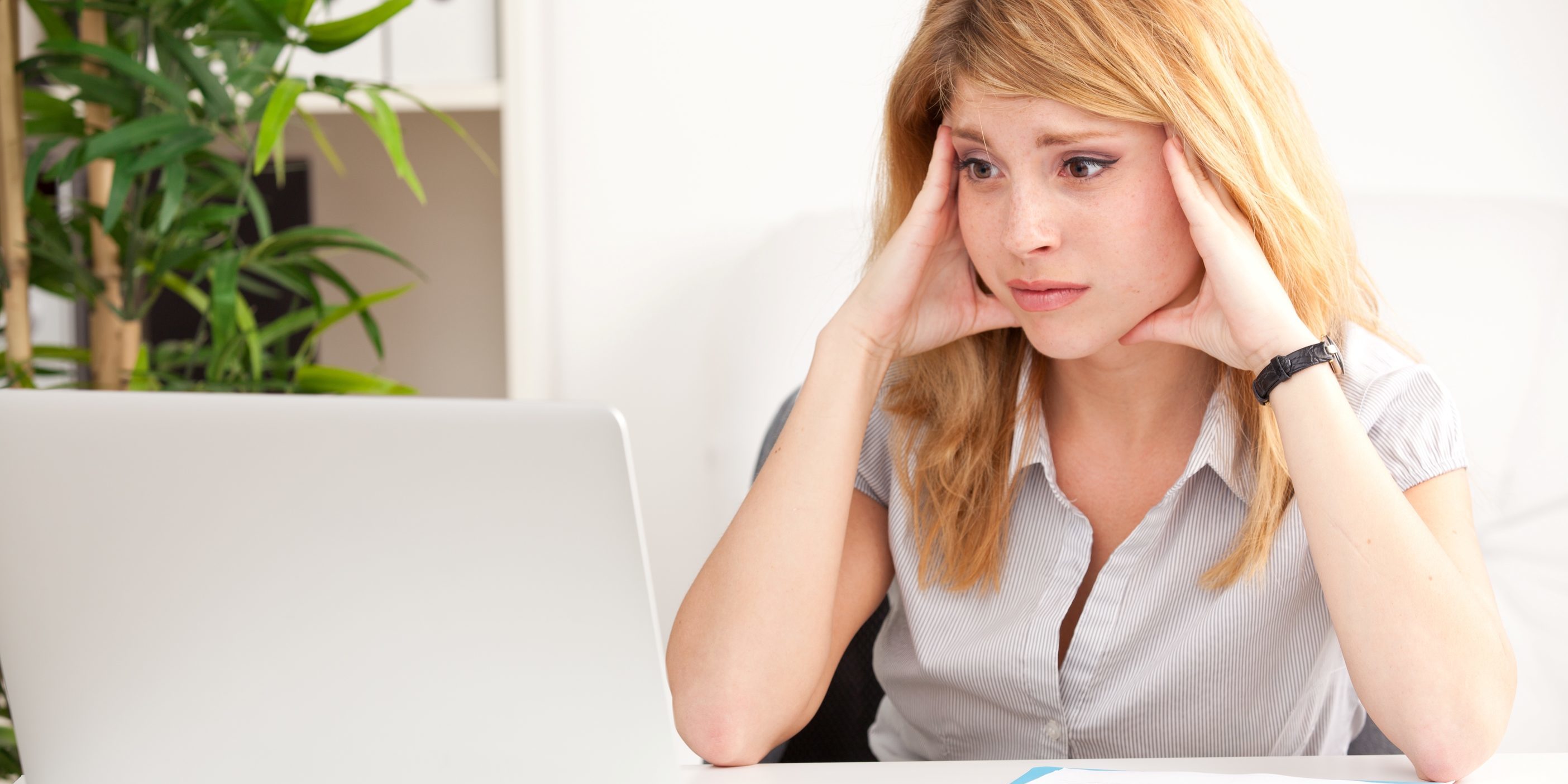 Managing online patient reviews | Vanguard Communications | Business woman concerned about reviews