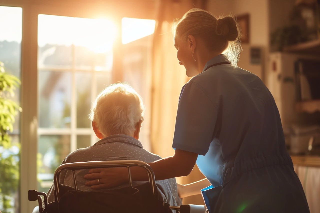 Caregiver helping elder person in assisted living facility | Vanguard Communications | Denver
