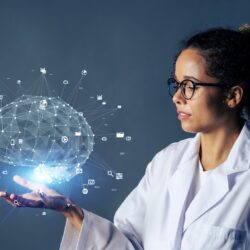 Black woman wearing lab coat with an AI-generated brain in her hand indicating ChatGPT use | Vanguard Communications | Denver, New Orleans, Jacksonville, FL